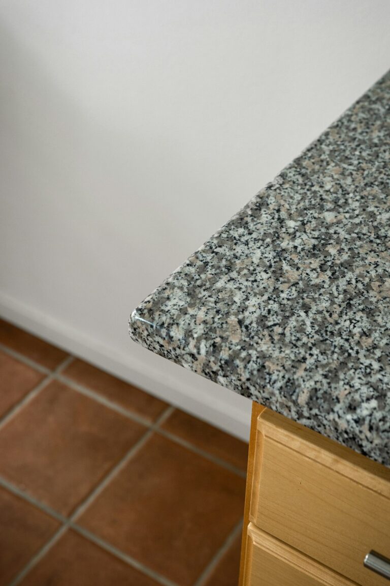Kitchen with stone samples, wood countertop, measuring tools, and cabinets under renovation.